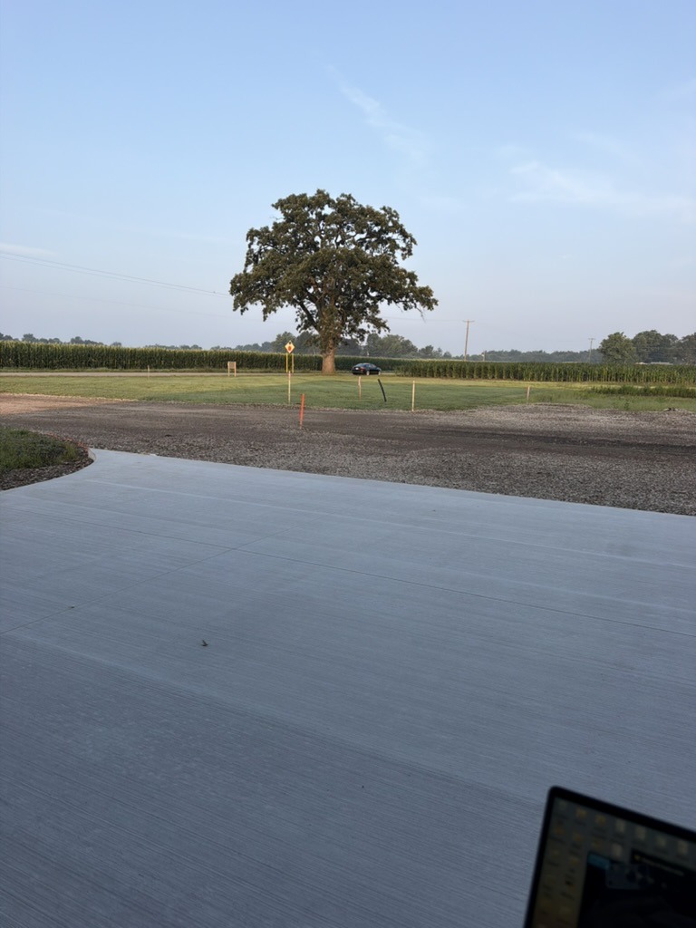 Gravel base and approach in front of Building 1 before asphalt paving — Kamp Kozy site