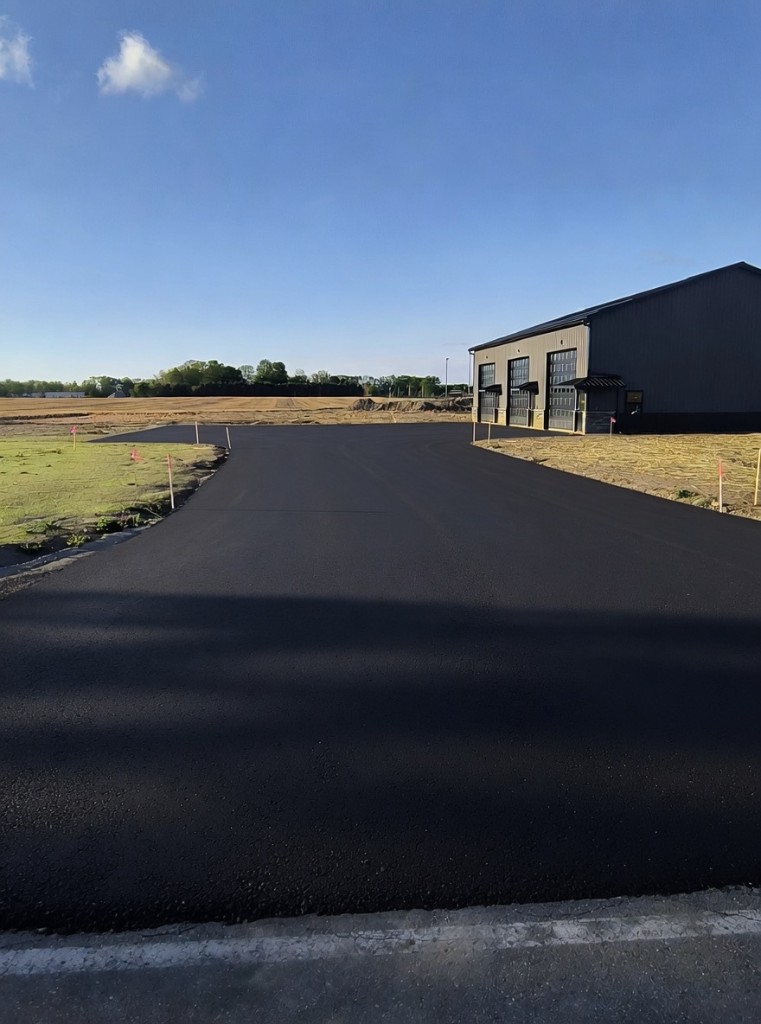 Design vision — paved asphalt driveway and parking entry in front of Building 1