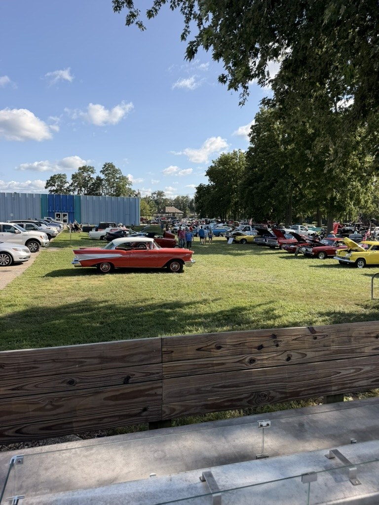 Red and white 1957 Chevrolet Bel Air at outdoor car show near Front Street Pizza Pub in Niles