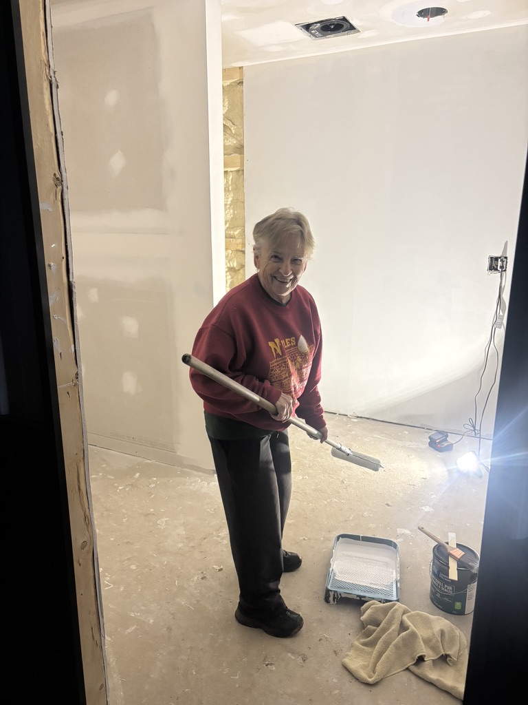 Hazel Stephenson rolling primer on the bathroom walls inside Unit 1 at Diamond Garage Condos