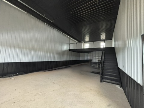 Main floor looking toward the mezzanine — full 50-foot depth with 18-foot ceilings