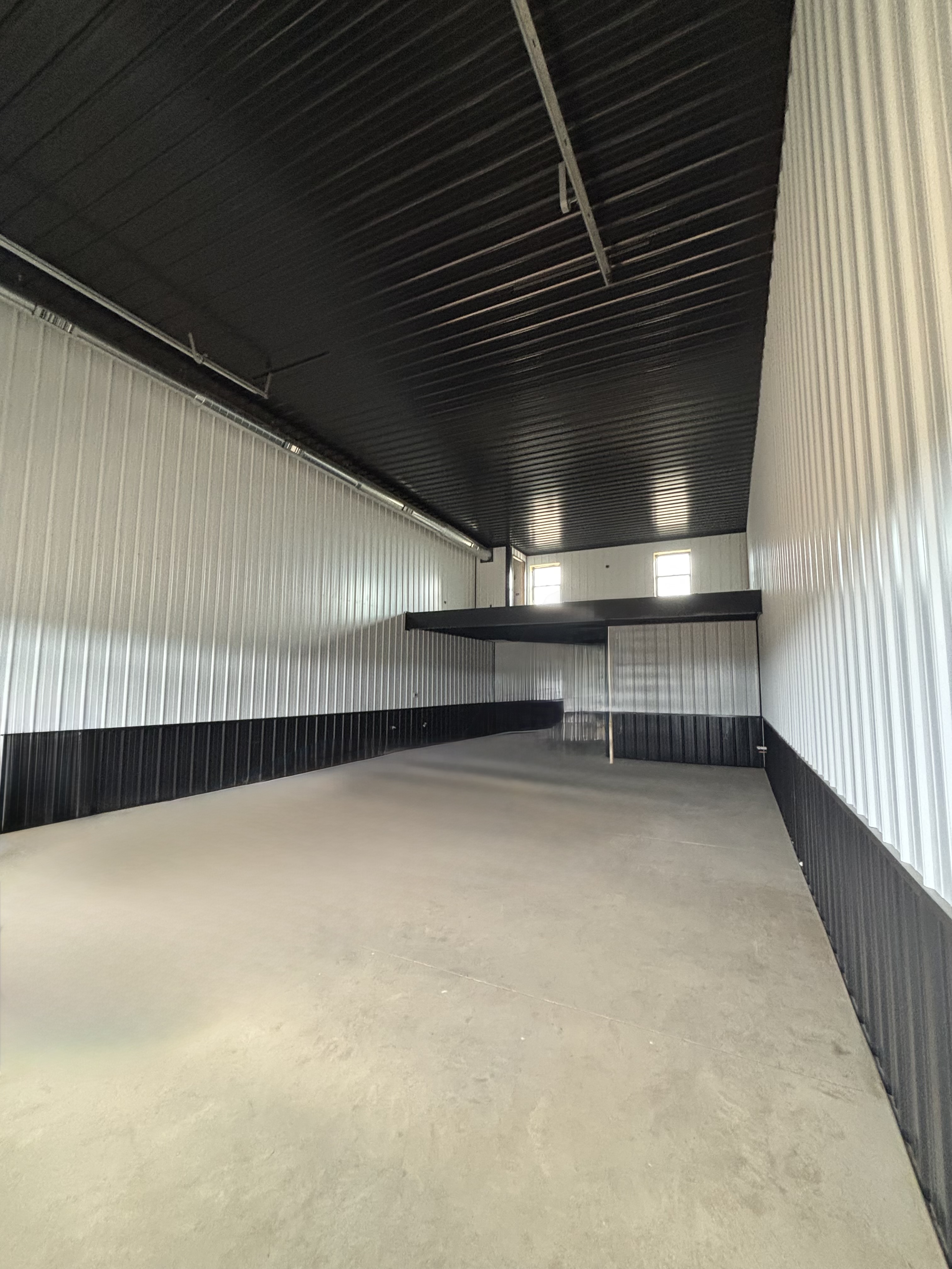 Interior bay — concrete floor, framed walls