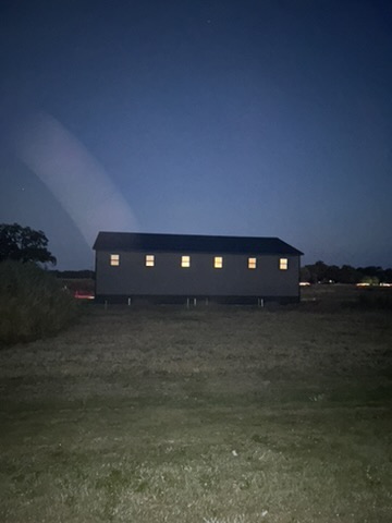 Building 1 at dusk with interior lights through the windows