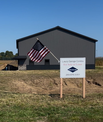 Diamond Garage Condos on-site signage and American flag