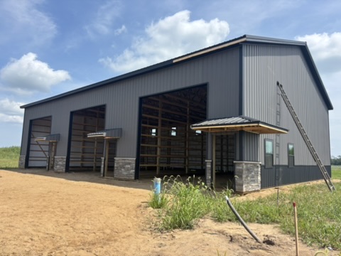 Building 1: three bays with stone bases and open door openings